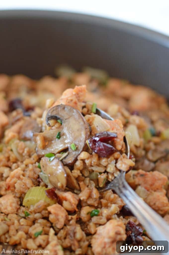 Healthy Meal Plan 6 A serving spoon scooping out a portion of savory turkey sausage stuffing from a baking dish.