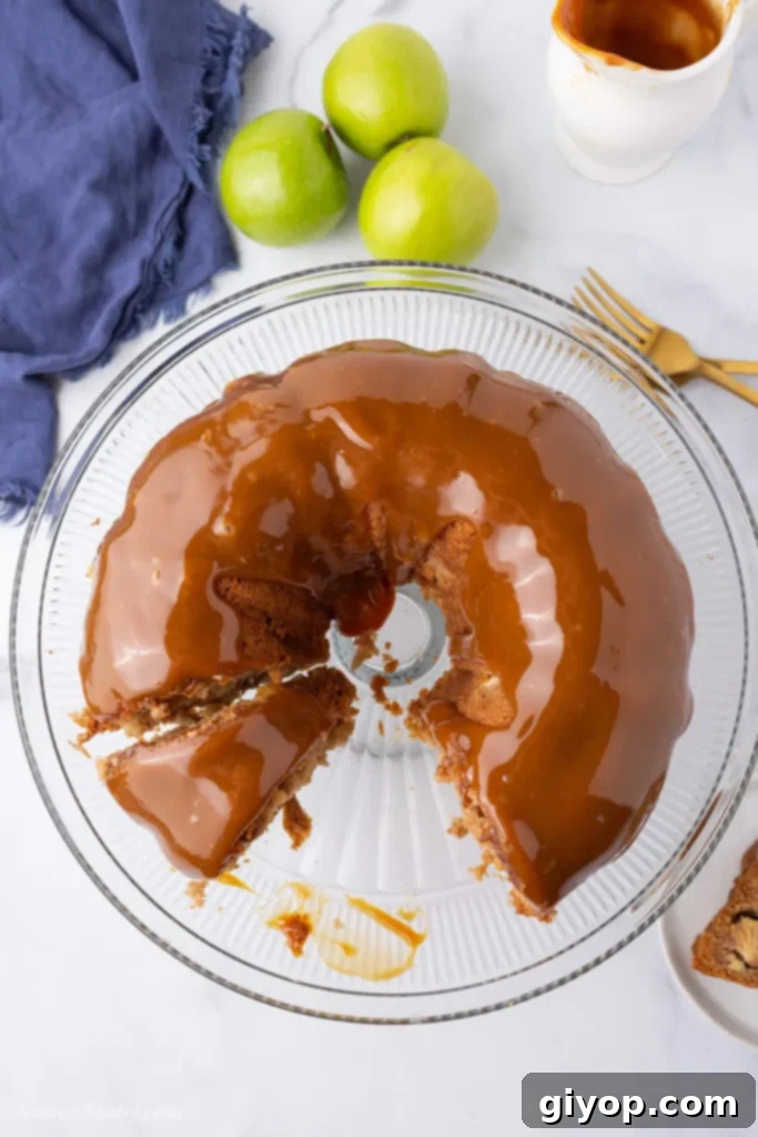 Meal Plan 7 A beautifully baked caramel apple bundt cake sits elegantly on a serving plate, with one slice already removed, revealing its moist interior.