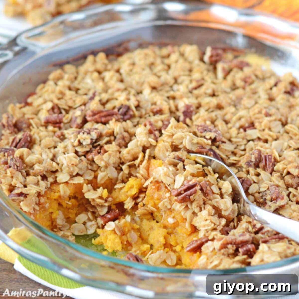 Sweet Golden Butternut Bake 2 A rounded glass dish with butternut squash placed on a wooden table.