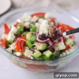 Close-up of a colorful Greek salad with feta and olives.