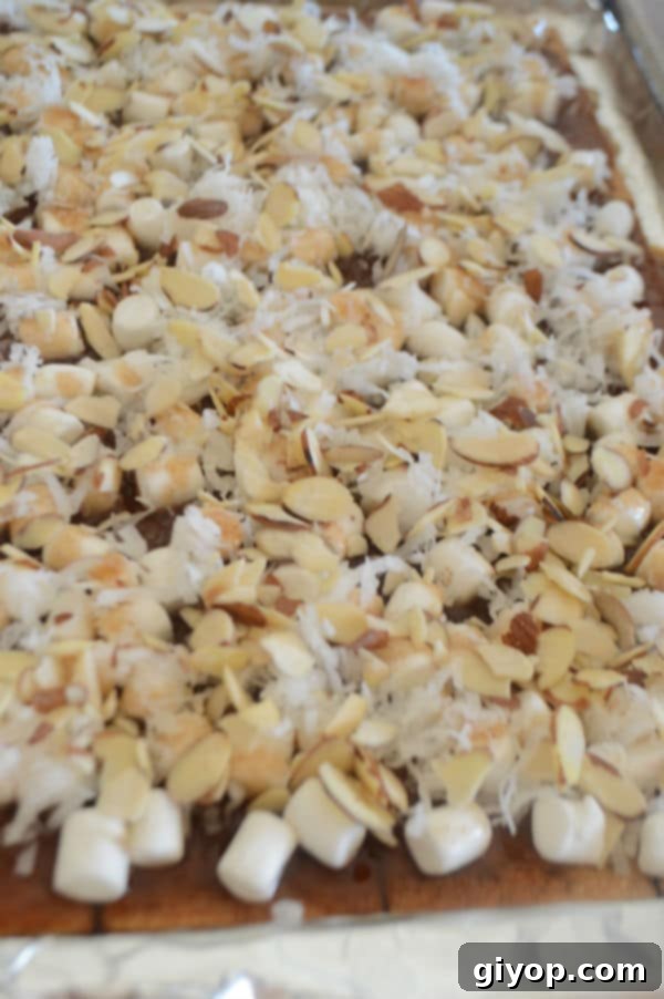 A close-up of Caramel Heavenlies on a plate, generously covered with nuts and coconut flakes