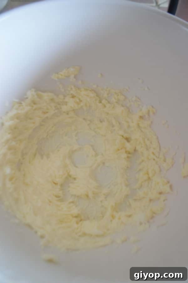 Close-up of a stack of golden-brown oatmeal chocolate chip cookies, showing their perfect texture with chewy middles and crisp edges