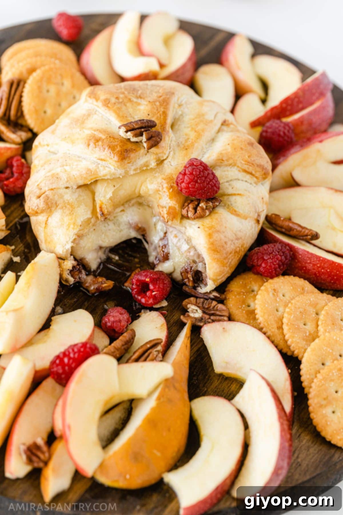 Golden, flaky puff pastry wrapped around warm, gooey brie with raspberry jam and pecans oozing out of the center.