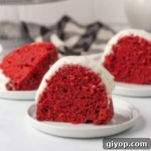 Slices of red velvet bundt on white dessert plates.