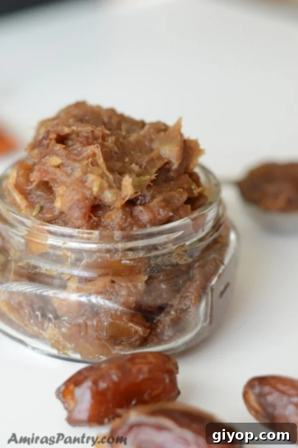 A close up of a jar filled with freshly made Agwa (date paste), ready for storage or use