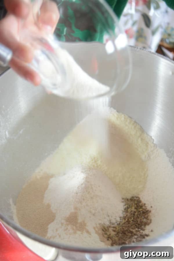Crispy Sesame Breadsticks 3 A metal bowl showing a mixture of dry ingredients for breadsticks.