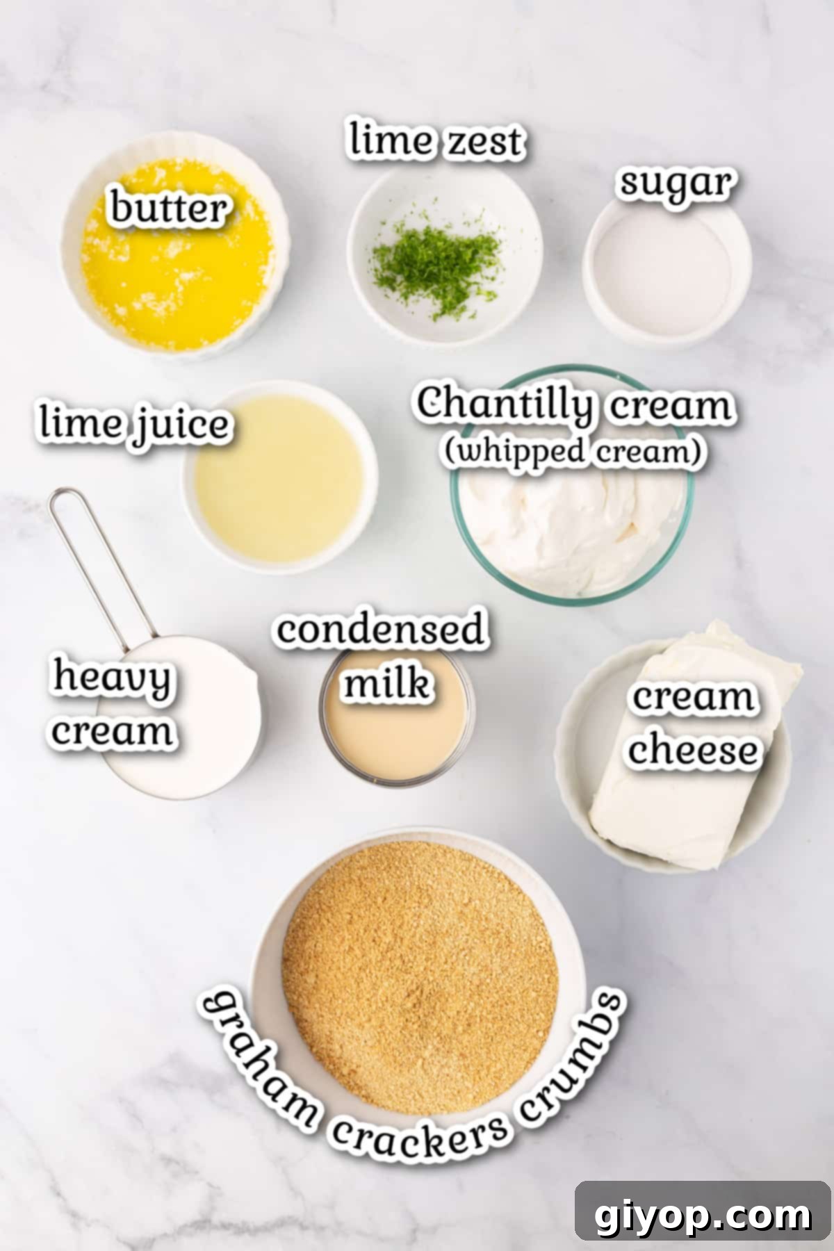 Recipe ingredients for key lime pie laid out neatly on a marble countertop.