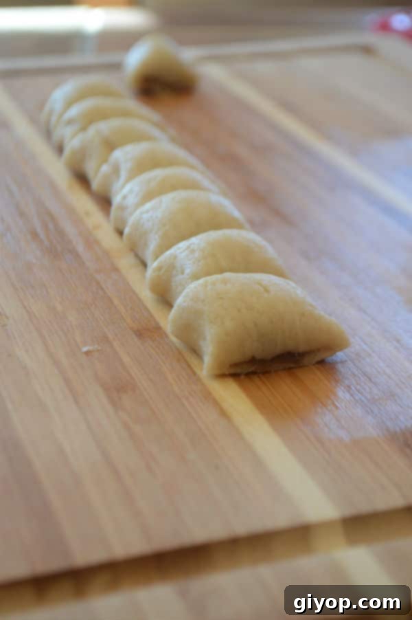 A wooden cutting board, with pieces of dough stuffed