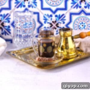 A table with a tray of Turkish coffee cups along with a pot and water, ready to be served.