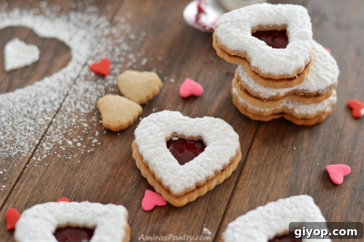 Spiced Cinnamon Cutout Treats 3 Cinnamon cookies stacked on top of each other with some heart candies on the table.