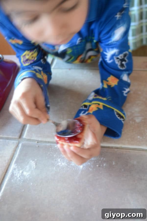 Spiced Cinnamon Cutout Treats 6 Kid decorating and filling up cinnamon cookies with jam.