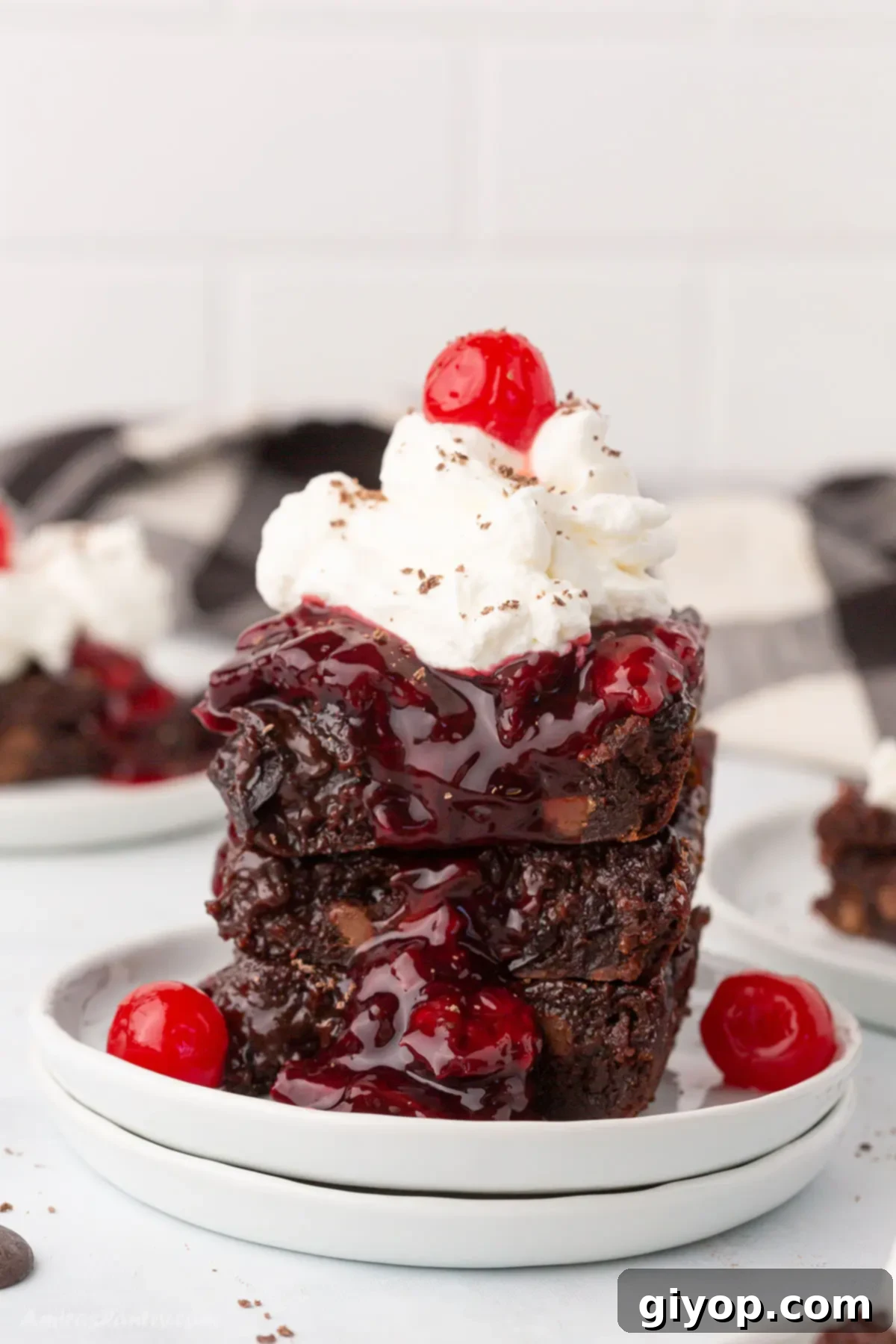 A perfectly sliced piece of Black Forest Brownie on a dessert plate, showcasing fudgy chocolate and bright cherry swirls.