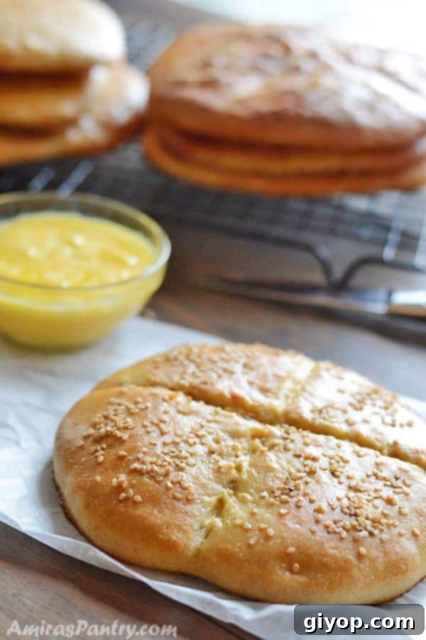 A close-up shot of a round Moroccan bread, Khobz, resting elegantly on a rustic wooden table, ready to be enjoyed.
