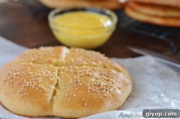 A close-up of a freshly baked Moroccan bread, Khobz, sliced into pieces on a serving board, showcasing its fluffy interior.