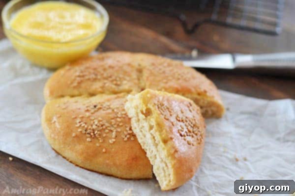 A freshly baked Moroccan bread on parchment paper, next to a sharp knife, highlighting its perfect golden crust.