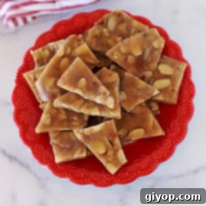 Top view of almond brittle in a red dish.