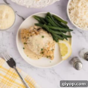 A white plate with a serving of creamy lemon chicken.