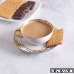 A fancy tea cup filled with creamy milk tea.