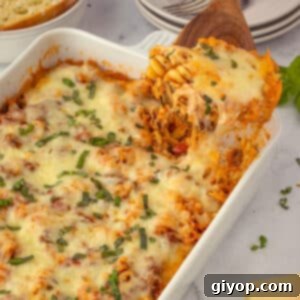A wooden spoon scooping some of the easy lasagna from the casserole dish.