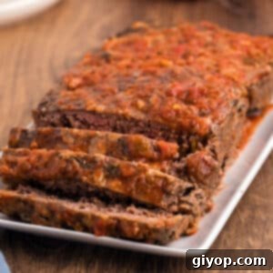 Aliced salsa meatloaf on a white serving rectangular plate.