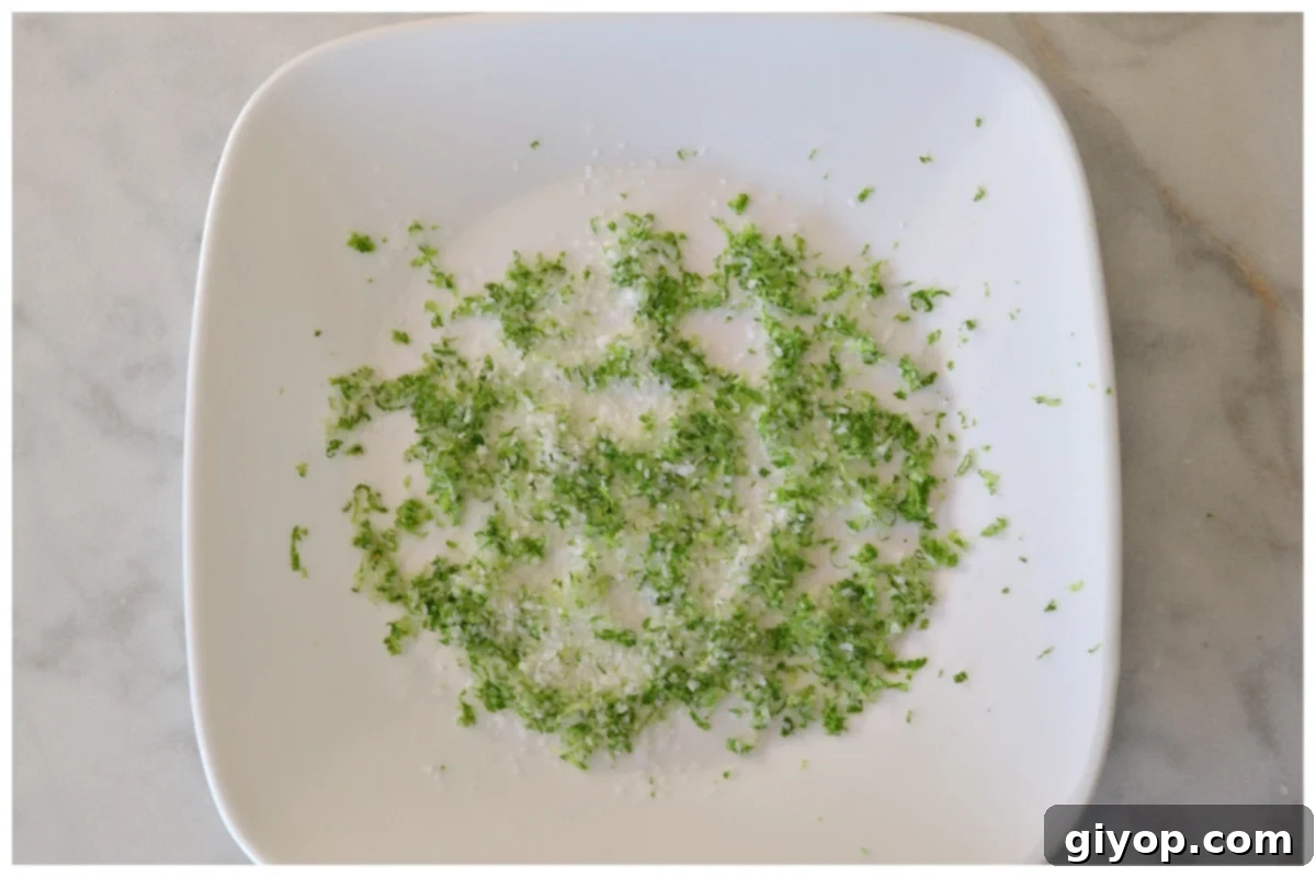 Lime zest and salt mixed on a white plate.