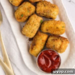 An oval serving dish with potato croquettes.