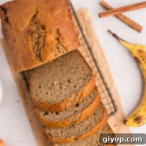 A slice of banana bread without butter on a plate, showing its moist crumb.
