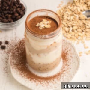 Decadent Tiramisu Overnight Oats 2 An overhead view of a jar with tiramisu overnight oats, topped with cocoa powder.
