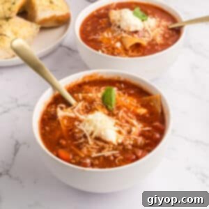 Easy Lasagna Soup (Crockpot Recipe) in a bowl with toppings.