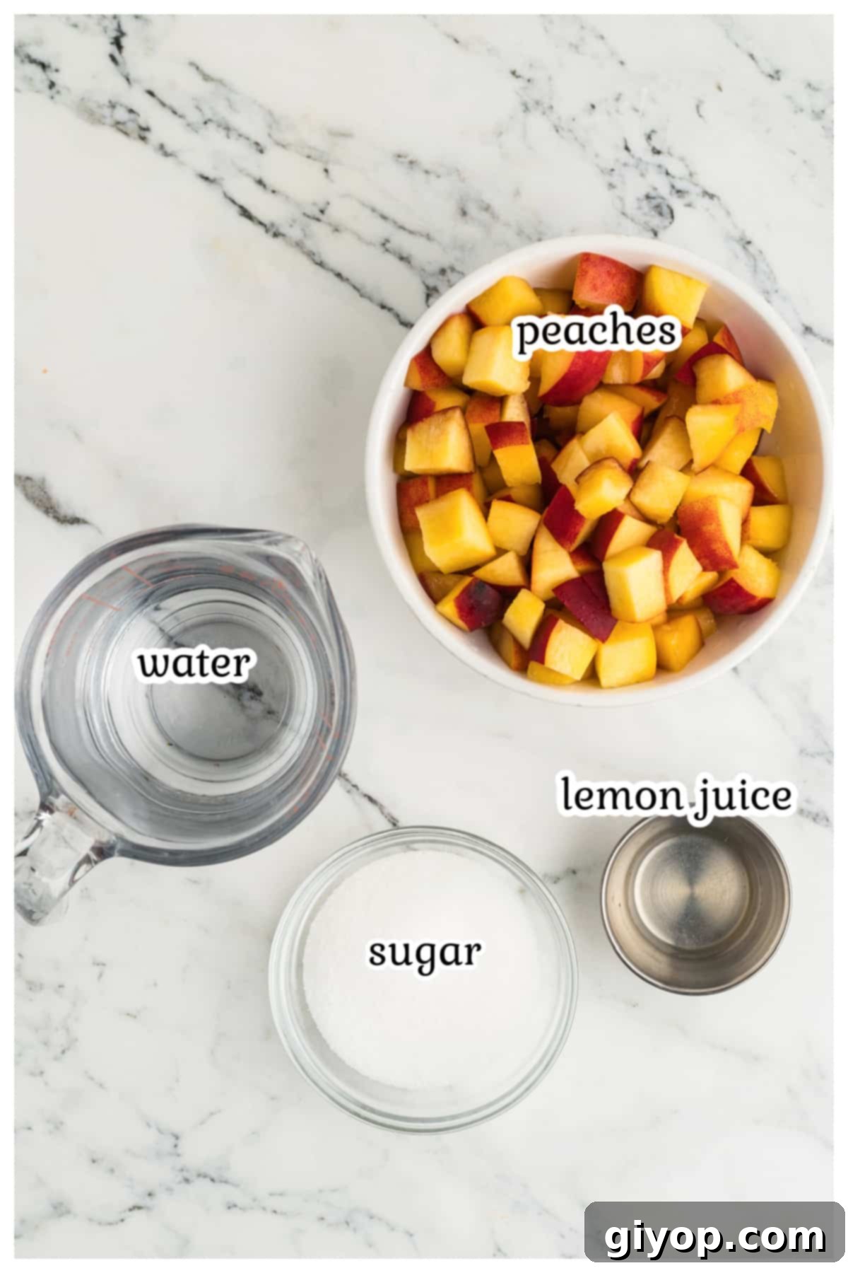 Fresh peaches, granulated sugar, water, and a lemon laid out on a clean marble surface, ready for making simple syrup.