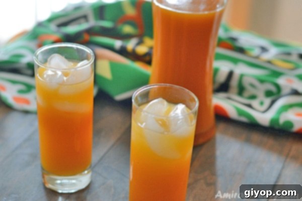 Three glass of apricot juice on a wooden table