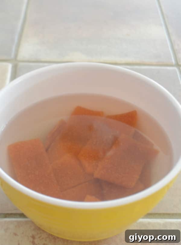 A close up of a bowl of dried apricot in water