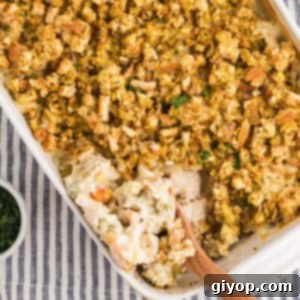 A white casserole dish with creamy chicken stuffing in it.