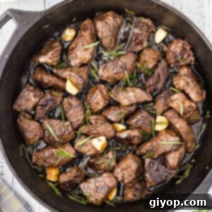 An overhead image of a black skillet with steak bites, ready to be served.
