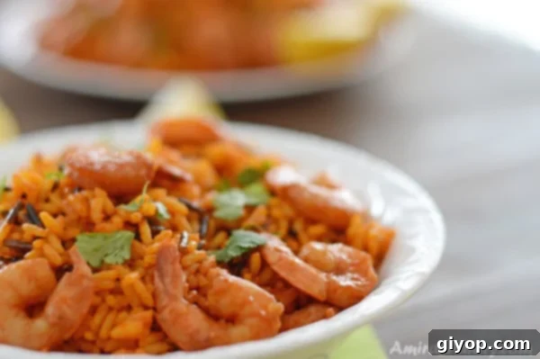 A plate of spicy whild rice and shrimp garnished with fresh cilantro.