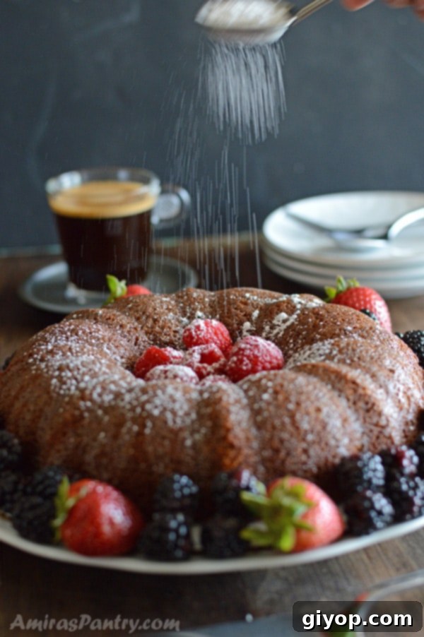 Caramelized Milk Powder Cake 3 A plate of food on a table, with powdered Cake and berries