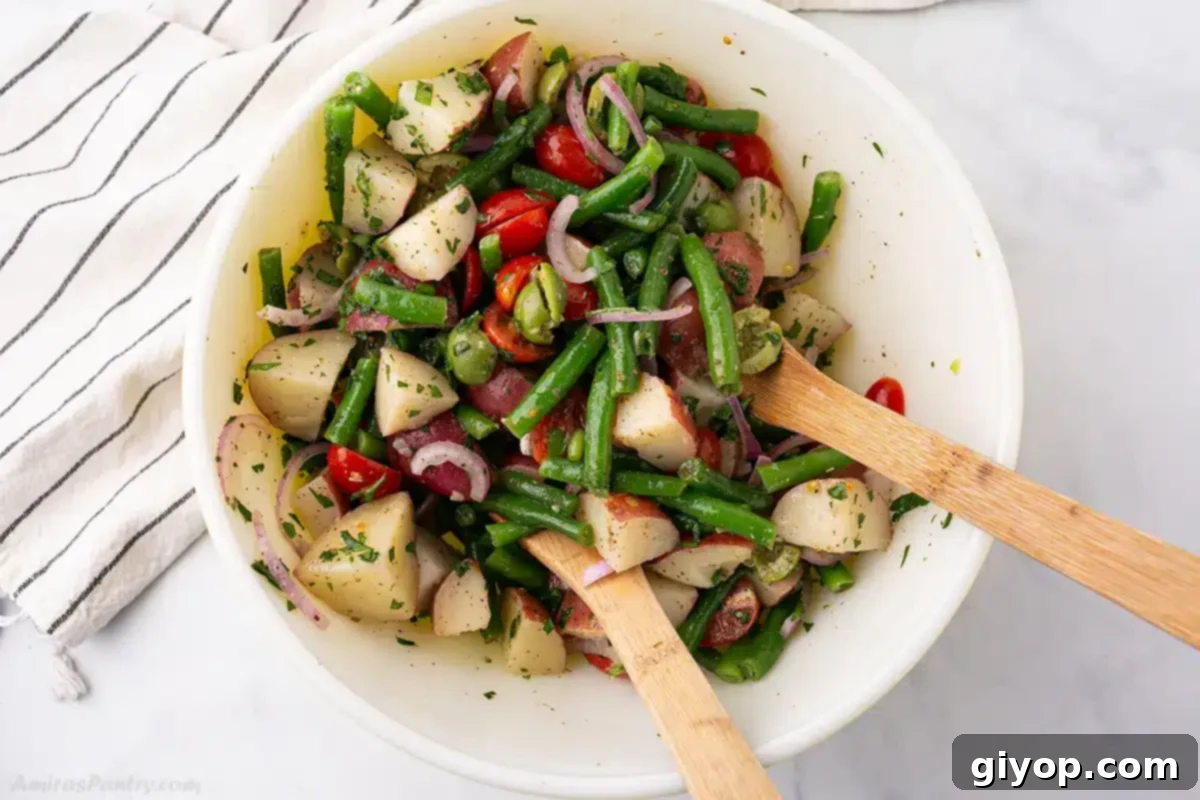 Zesty Italian Potato Salad 11 An overhead image of a bowl of Italian salad with potatoes and green beans.