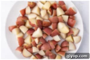 Zesty Italian Potato Salad 6 Drained potatoes cooling in a shallow dish.