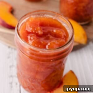 A jar of freshly made peach jam on a countertop, ready to be enjoyed.
