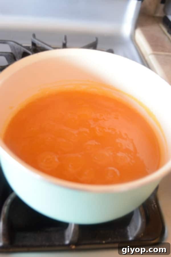 Sun-Dried Apricot Qamar Al-Deen Pudding 7 A pan of Apricot juice on a stove top