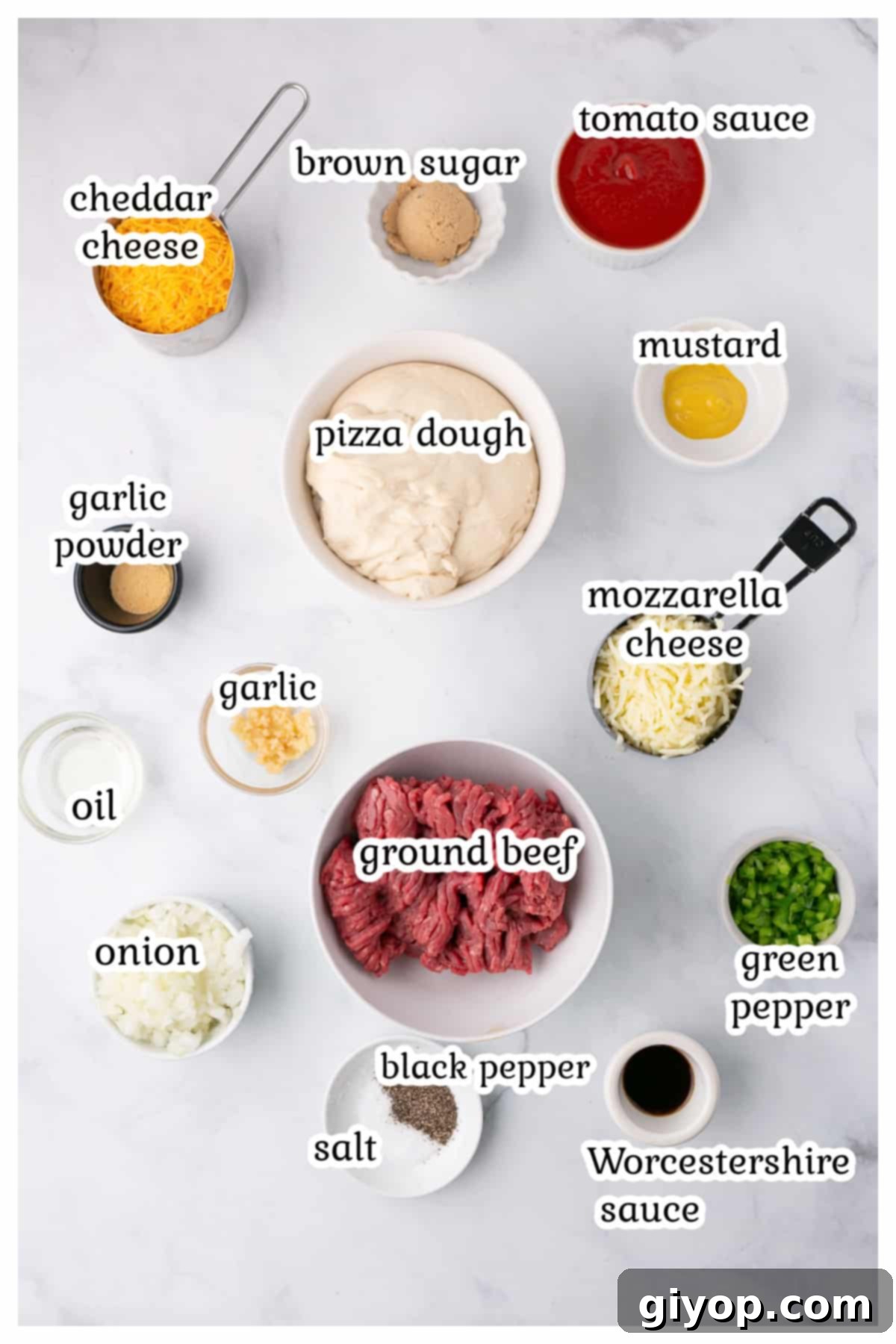 A collection of fresh ingredients laid out, including olive oil, onions, green peppers, ground beef, brown sugar, Worcestershire sauce, tomato sauce, mustard, garlic powder, and pizza dough, ready for making Sloppy Joe Pizza.