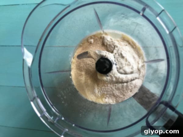 Moroccan Baghrir Thousand Hole Semolina Pancakes 4 Step 1: Dry ingredients for fluffy Moroccan Baghrir being added to a blender for mixing.