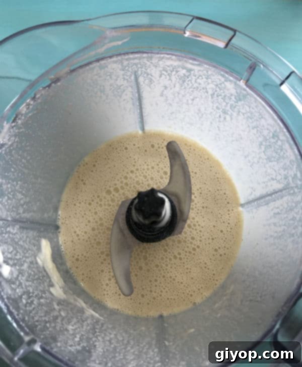 Moroccan Baghrir Thousand Hole Semolina Pancakes 5 Step 2: Wet ingredients being added to the dry ingredients in the blender for Moroccan Baghrir batter.