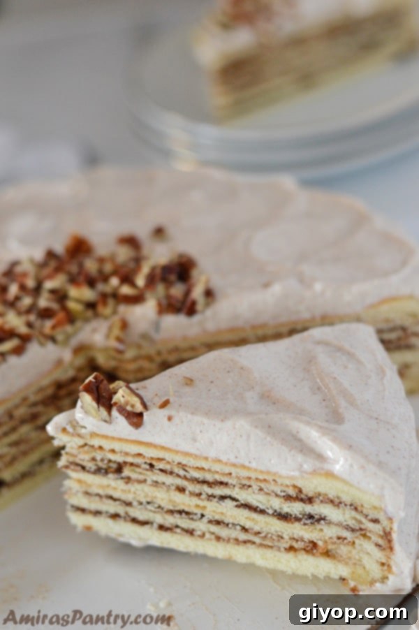 A beautifully decorated vanilla cinnamon cake, adorned with a light frosting and a sprinkle of spices, radiating a warm, inviting glow.