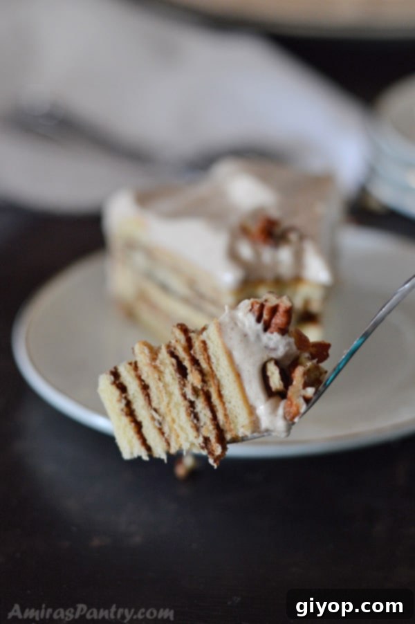 A perfectly baked moist cinnamon cake, showcasing its inviting golden-brown crust and tender, spiced interior, ready to be sliced.