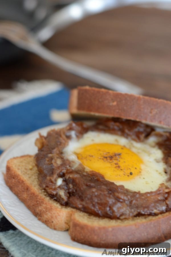 A close-up shot of a flavorful sandwich featuring a perfectly fried egg and rich date paste, illustrating one delicious and convenient way to enjoy Egg Agwa on the go.