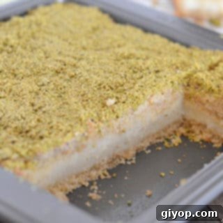Pistachio-Packed Maamoul with Velvety Ashta 15 A piece of cake in a pan with maamoul mad pistachios