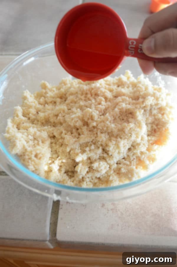 Pistachio-Packed Maamoul with Velvety Ashta 7 The semolina dough mixture after being fully combined with butter and fragrances, resembling wet sand, covered and resting.