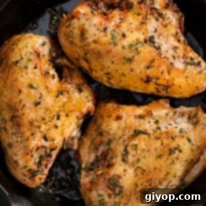 Quick and Flavorful Air Fryer Chicken Breasts 2 An overhead image of cooked bone-in chicken breasts, garnished with fresh herbs.
