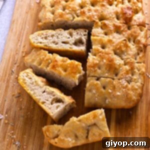 Rise and Shine Focaccia 2 Slices of fluffy focaccia bread on a wooden cutting board, ready to be served.